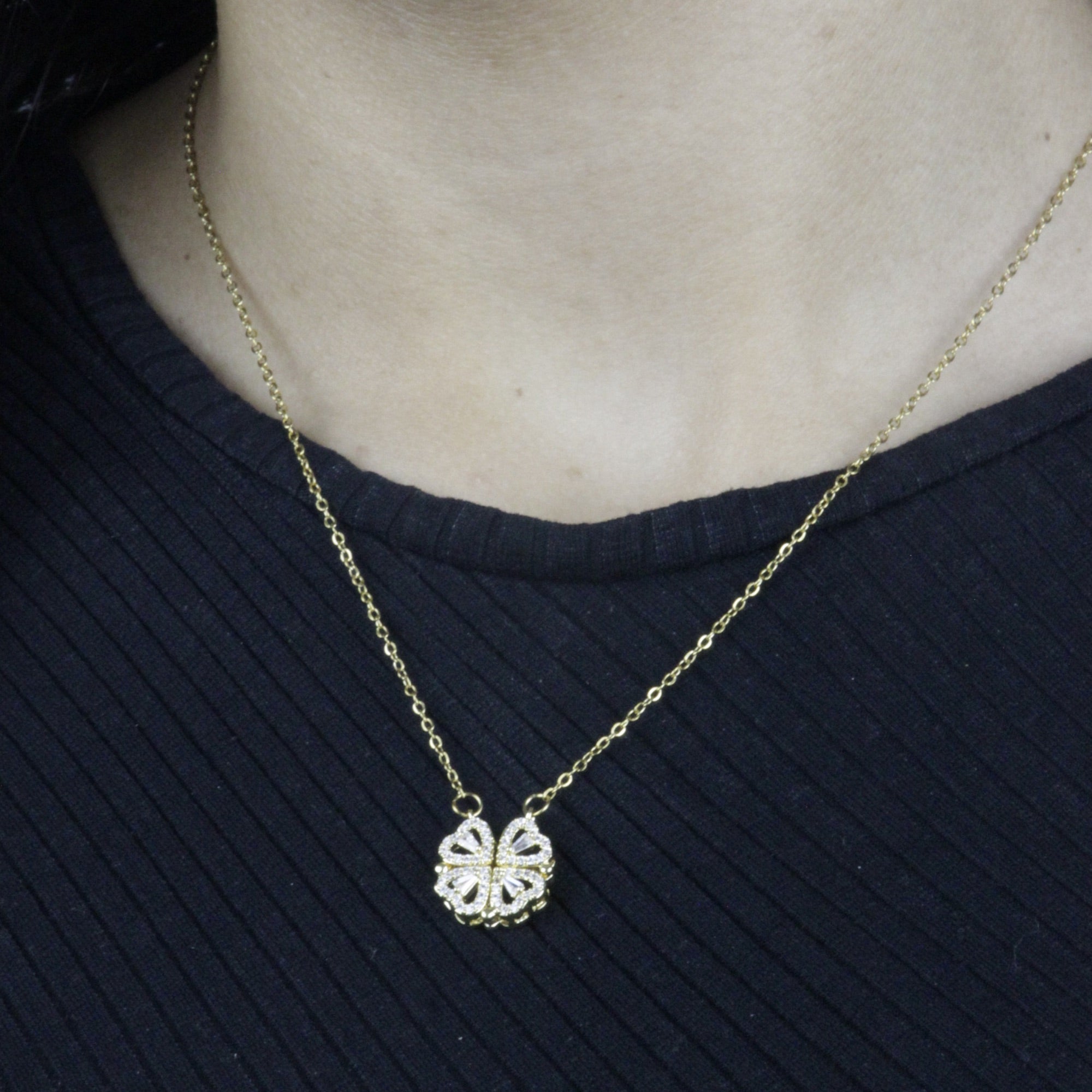 Colar_Trevo_de_Quatro_Folhas_Magnetico_dourado_usado_no_pescoco_com_pingente_fechado.