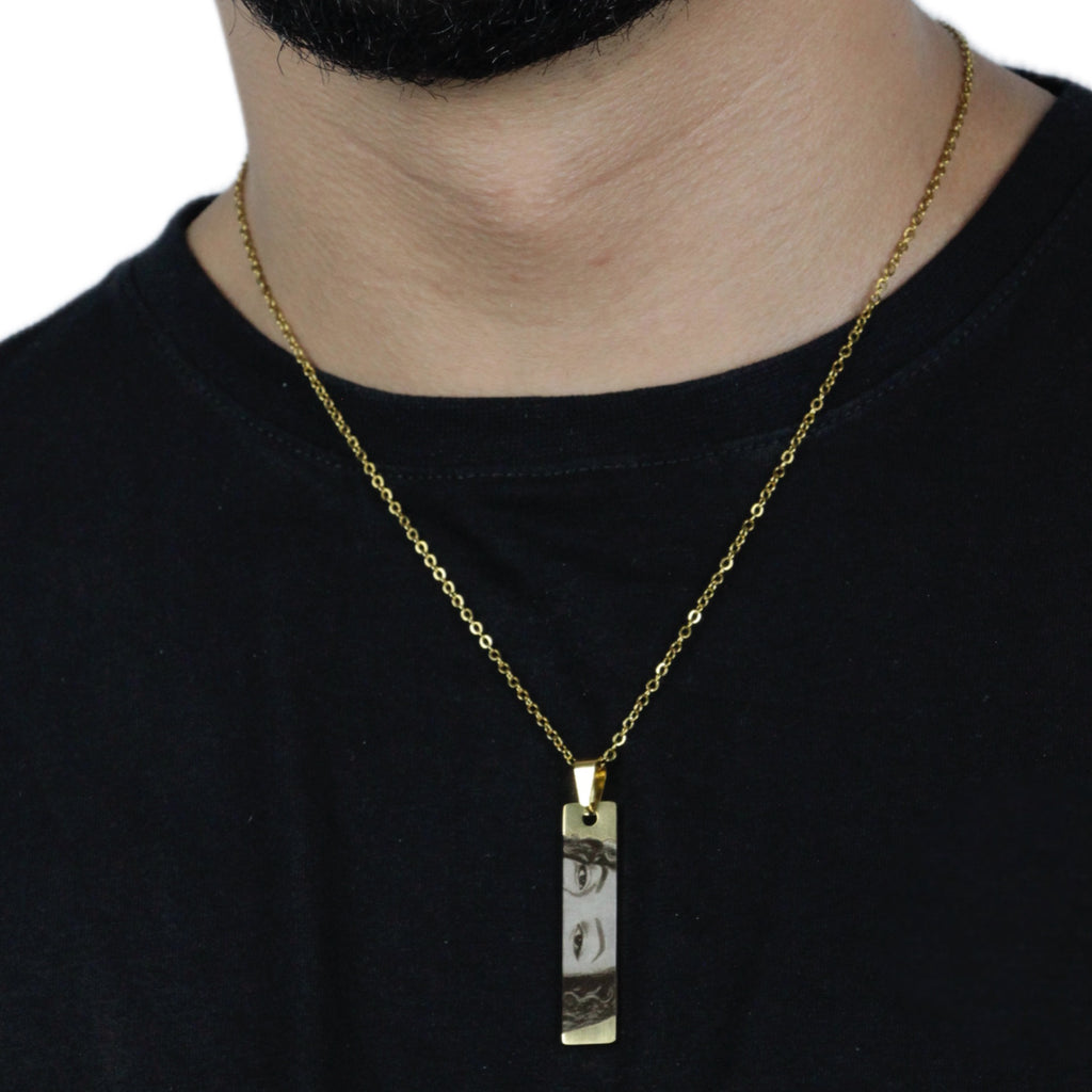 Homem_usando_colar_do_olhar_dourado_pingente_retangular_com_gravacao_do_olhar